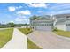 Charming two-story home with a paved driveway and attached two-car garage at 701 Dennis Ave, Orlando, FL 32807