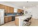 Stylish kitchen featuring a white countertop, wood cabinets, stainless steel appliances, and pendant lighting at 701 Dennis Ave, Orlando, FL 32807