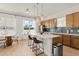 Modern kitchen features a central island with counter seating, ample cabinet space and stainless appliances at 701 Dennis Ave, Orlando, FL 32807