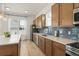 Well-lit kitchen features wood cabinets, stainless steel appliances, and a white countertop with a tile backsplash at 701 Dennis Ave, Orlando, FL 32807
