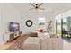 Bright living room with a sectional sofa, TV, decor, and large windows bringing in natural light at 701 Dennis Ave, Orlando, FL 32807