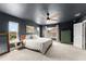 Spacious bedroom featuring dark walls, a ceiling fan, and abundant natural light at 701 Dennis Ave, Orlando, FL 32807