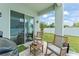 Covered patio offers comfortable seating overlooking a well-kept backyard with putting green at 701 Dennis Ave, Orlando, FL 32807
