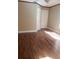 Cozy bedroom featuring wood flooring, baseboard trim, and natural light at 706 Lighthouse Ct, Altamonte Springs, FL 32714