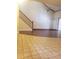Open living room features staircase and wood floors adjoining tiled entry at 706 Lighthouse Ct, Altamonte Springs, FL 32714