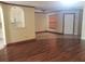 Living room area with wood flooring that flows into the kitchen with tile at 706 Lighthouse Ct, Altamonte Springs, FL 32714