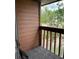 Balcony with wood railing and siding that offers views of trees at 707 Carpenters Way # 50, Lakeland, FL 33809