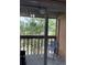 Balcony with wood railing and a chair to relax and enjoy the view at 707 Carpenters Way # 50, Lakeland, FL 33809