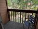 Balcony with wood railing that offers views of trees and a place to relax at 707 Carpenters Way # 50, Lakeland, FL 33809