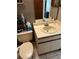 Bathroom featuring vanity with sink, toilet, and neutral-toned tile flooring at 707 Carpenters Way # 50, Lakeland, FL 33809