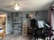 Bedroom with a ceiling fan and a desk, and stacked storage bins and shelves with various decor at 707 Carpenters Way # 50, Lakeland, FL 33809