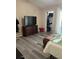 Bedroom with gray vinyl floors, a dresser with a TV, and closet for ample storage at 707 Carpenters Way # 50, Lakeland, FL 33809