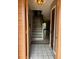 Entryway showing wood-look flooring, stairway to upper level, and open view to living area at 707 Carpenters Way # 50, Lakeland, FL 33809