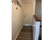 Upstairs hallway featuring wood-look flooring and door to the upper level at 707 Carpenters Way # 50, Lakeland, FL 33809