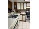Spacious kitchen featuring white cabinets, stainless steel appliances, and tile flooring at 707 Carpenters Way # 50, Lakeland, FL 33809