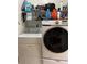 Laundry room with washer and dryer; storage shelves stocked with supplies at 707 Carpenters Way # 50, Lakeland, FL 33809