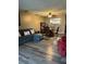 Cozy living room with a sectional sofa, wood floors, and view into the kitchen at 707 Carpenters Way # 50, Lakeland, FL 33809