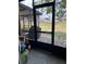 Screened-in porch overlooks the lawn and includes outdoor seating and a grill at 707 Carpenters Way # 50, Lakeland, FL 33809