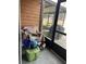 Enclosed porch with a view of the outdoors, complete with furniture and grill at 707 Carpenters Way # 50, Lakeland, FL 33809