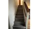 Carpeted staircase leads to upper level of home with wooden handrail at 707 Carpenters Way # 50, Lakeland, FL 33809