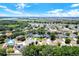Scenic aerial view of a residential community with lush green trees and blue lakes at 809 Deer Glen Ct, Fruitland Park, FL 34731