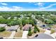 A beautiful aerial view of a white and gray two-story home with a manicured front yard at 809 Deer Glen Ct, Fruitland Park, FL 34731