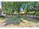Spacious backyard featuring mature trees and a wood privacy fence at 809 Deer Glen Ct, Fruitland Park, FL 34731