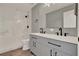 Beautiful bathroom with dual sink vanity, granite countertops, and marble-walled shower at 809 Deer Glen Ct, Fruitland Park, FL 34731