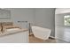 Bathroom featuring a single sink vanity with granite counters and a modern freestanding tub at 809 Deer Glen Ct, Fruitland Park, FL 34731