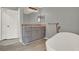 Bathroom featuring a double sink vanity, granite counters, and a modern freestanding tub at 809 Deer Glen Ct, Fruitland Park, FL 34731