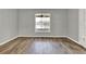 A light-filled bedroom showcases wood-look tile flooring and a window at 809 Deer Glen Ct, Fruitland Park, FL 34731