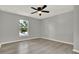 Bright bedroom with neutral walls, hardwood flooring, and a view of the outdoors at 809 Deer Glen Ct, Fruitland Park, FL 34731