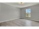 Sunlit bedroom featuring neutral walls and modern flooring at 809 Deer Glen Ct, Fruitland Park, FL 34731