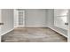 The bedroom is bright with new flooring and a white paneled door at 809 Deer Glen Ct, Fruitland Park, FL 34731
