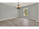 Dining room features gray walls, light hardwood floors, and decorative chandelier at 809 Deer Glen Ct, Fruitland Park, FL 34731