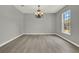 Dining room features gray walls, light hardwood floors, and decorative chandelier at 809 Deer Glen Ct, Fruitland Park, FL 34731