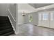 View of entryway that features gray walls, light hardwood floors, and staircase at 809 Deer Glen Ct, Fruitland Park, FL 34731