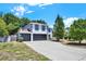 Two-story home boasts a three-car garage, crisp white paint, and contrasted black trim at 809 Deer Glen Ct, Fruitland Park, FL 34731