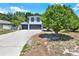 Two-story home boasts a three-car garage, crisp white paint, and contrasted black trim at 809 Deer Glen Ct, Fruitland Park, FL 34731