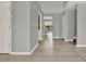Entry hallway features gray walls, light hardwood floors, and updated trim at 809 Deer Glen Ct, Fruitland Park, FL 34731