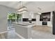 New kitchen with stainless appliances, white subway tile and granite countertops at 809 Deer Glen Ct, Fruitland Park, FL 34731