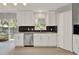 Well-lit kitchen featuring white cabinetry, stainless steel appliances, and a modern backsplash at 809 Deer Glen Ct, Fruitland Park, FL 34731