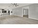 Open living room next to the kitchen, with modern ceiling fan at 809 Deer Glen Ct, Fruitland Park, FL 34731