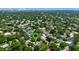 Aerial view showcasing lush greenery with Universal Studios visible in the distance, highlighting the neighborhood's location at 8655 Shady Glen Dr, Orlando, FL 32819