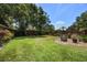 Picturesque backyard with a wooden fence, mature trees, and a well-manicured lawn at 8655 Shady Glen Dr, Orlando, FL 32819