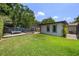 The backyard has a grassy lawn, a wooden deck with seating, and a view of a shed-like structure with two windows at 8655 Shady Glen Dr, Orlando, FL 32819