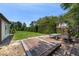 Backyard view of deck, lush greenery, and bordering fence at 8655 Shady Glen Dr, Orlando, FL 32819