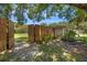Tranquil backyard with mature trees, wooden fence, and a charming swing at 8655 Shady Glen Dr, Orlando, FL 32819