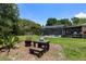 Expansive backyard featuring a screened pool, mature trees, and lush green lawn at 8655 Shady Glen Dr, Orlando, FL 32819