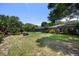 Large backyard with a screened pool area, mature trees, and well-maintained lawn at 8655 Shady Glen Dr, Orlando, FL 32819
